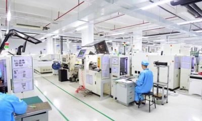 Technicians working in a clean display electronics production and inspection area