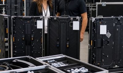 Event buyer and technician inspecting rental LED cabinets and flight cases