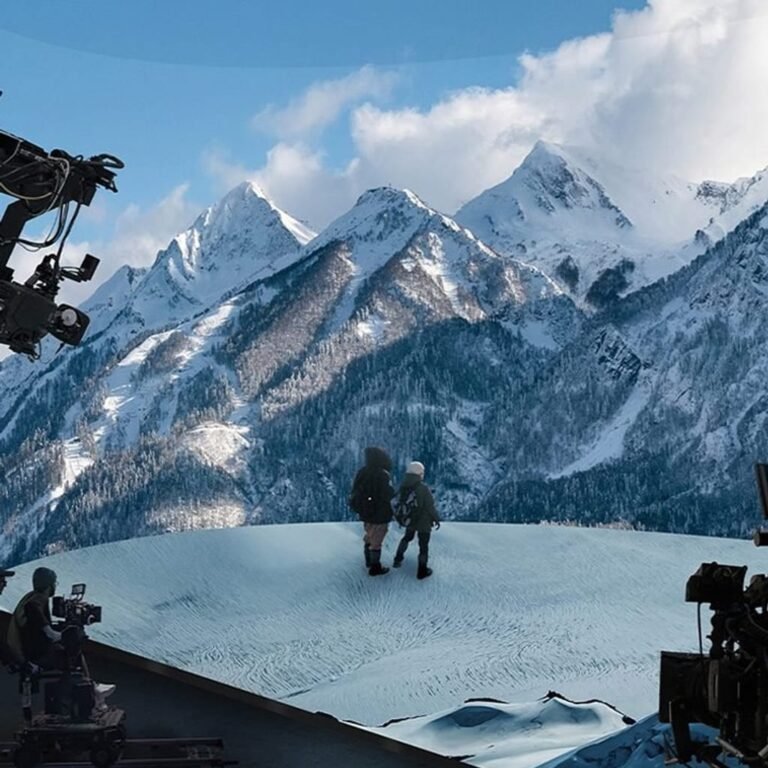 Virtual production LED stage showing a camera-facing scenic background